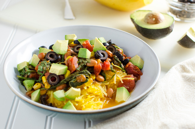 Easy Spaghetti Squash with Pinto Beans and Arugula - this simple recipe offers a lovely blend of Mexican cuisine inspired flavors - squash is cooked in a slow cooker for added convenience | VeggiePrimer.com