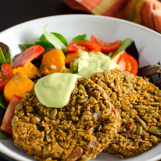 Spicy Lentil Quinoa Burgers with avocado dressing - these gluten-free vegan veggie patties offer a flavorful blend of protein-rich plant-based ingredients with a little kick. | VeggiePrimer.com