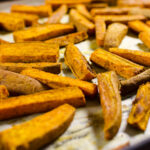 Curried Baked Sweet Potato Fries - sweet curry powder adds a lovely aromatic dimension to this gluten-free vegan recipe. The fries taste delicious and make your house smell delicious! | VeggiePrimer.com
