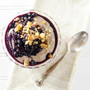 bowl of chia seed pudding topped with blueberries and walnuts