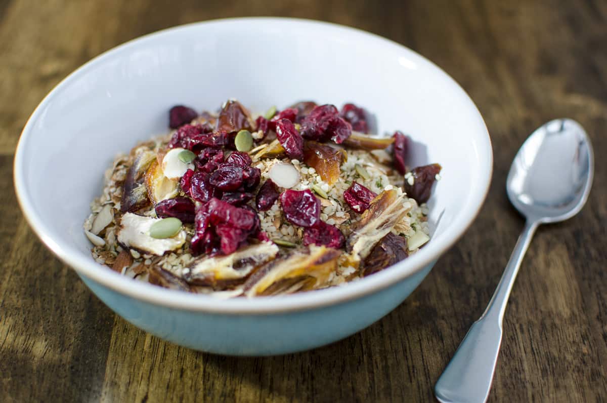 bowl of old-fashioned oats topped with dried fruit and seeds